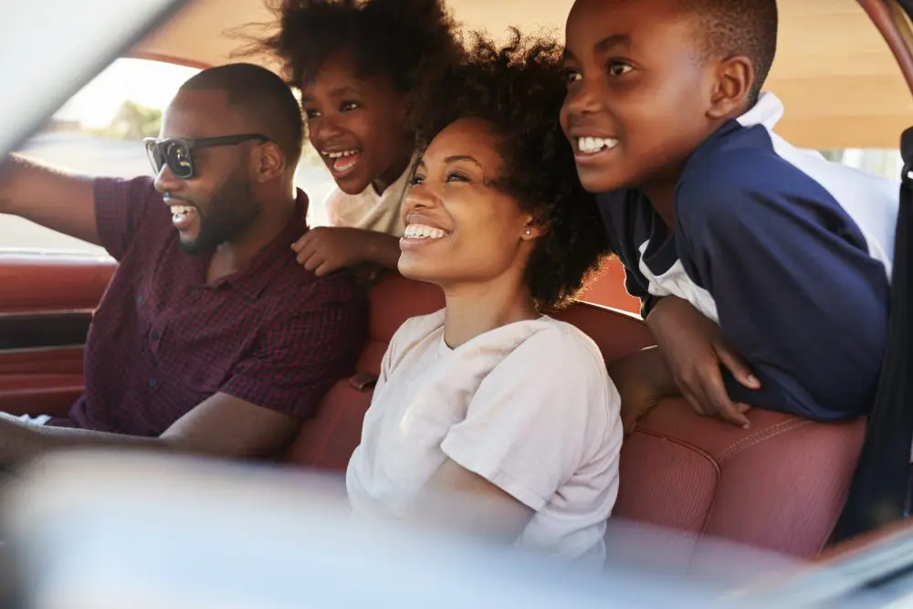Black family riding around in a car 