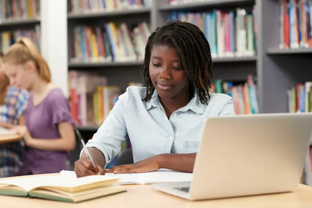 Black girl in middle school doing homework