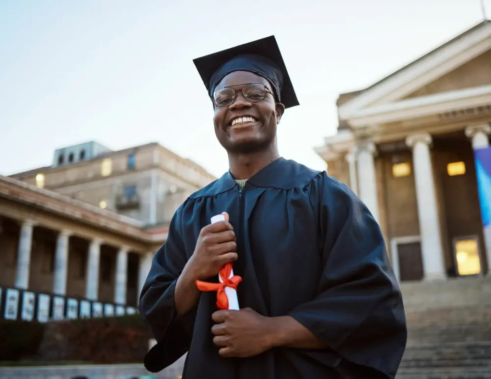 Black student graduating with a diploma in his hands 