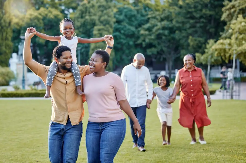 Black Family doing kids activities in a park