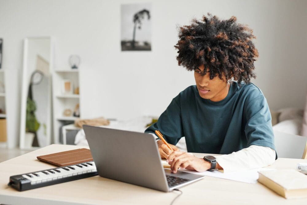 Young Black Man working on a laptop